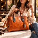 Woman holding a brown leather handbag in an outdoor setting